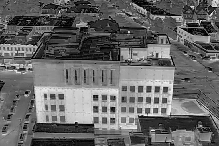 Aerial thermal image of a large low-rise commercial building and the streets around it